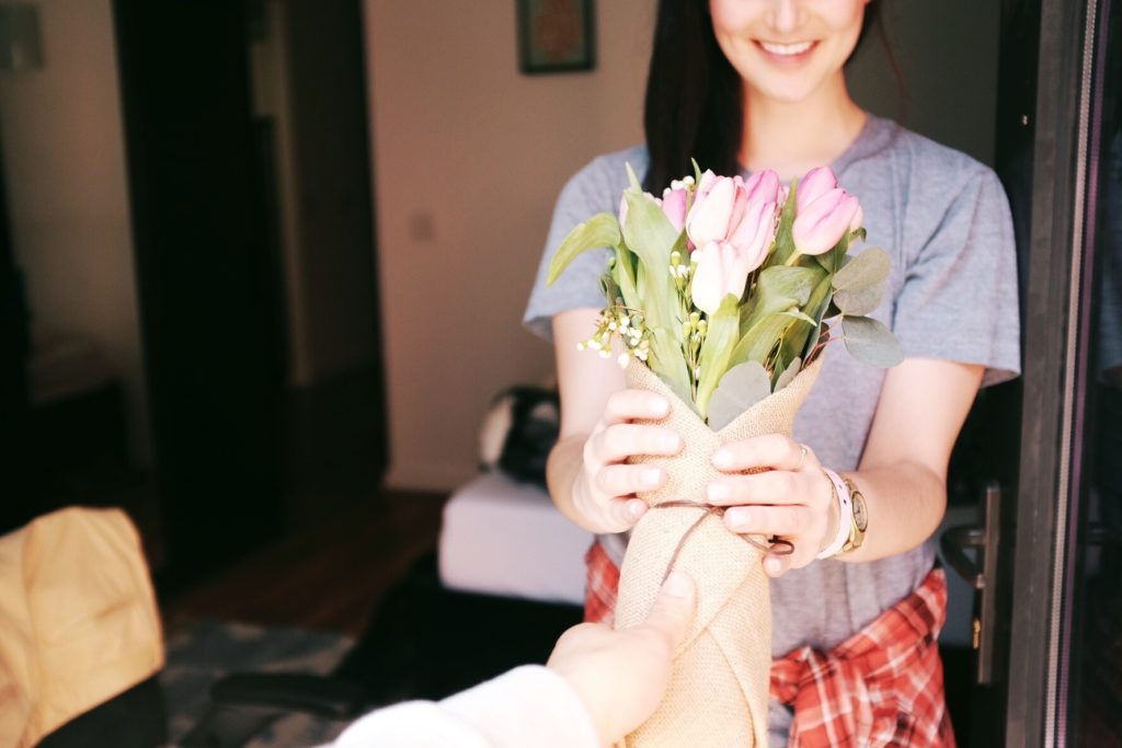 Man giving woman mother's day flowers.