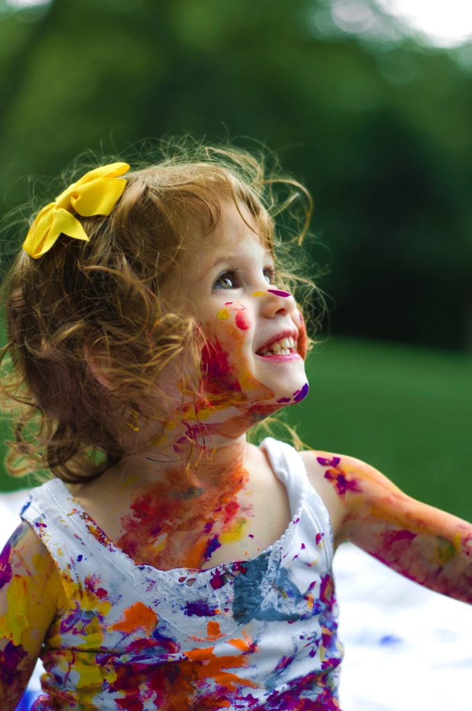 Happy girl with paint on her face. Alison Escalante MD