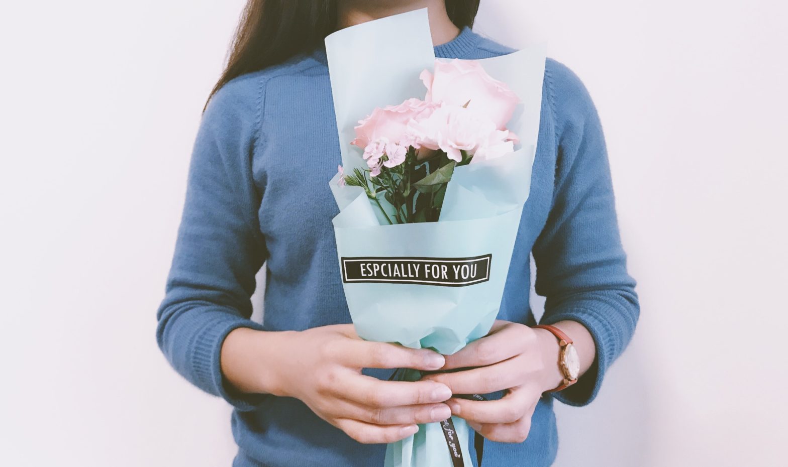 Woman receiving flowers that say especially for you.