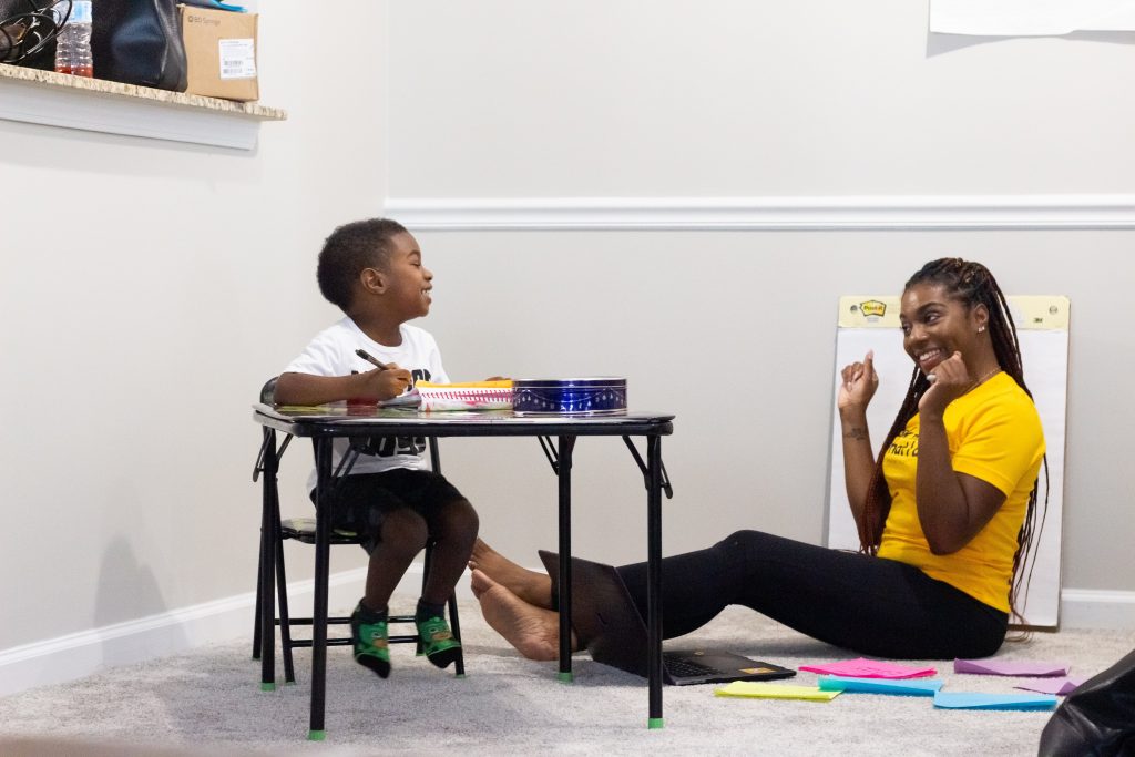 Mother teaching young child school skills.