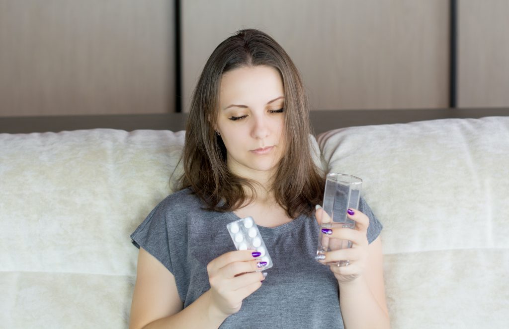 Mother parent who is sick holding pills